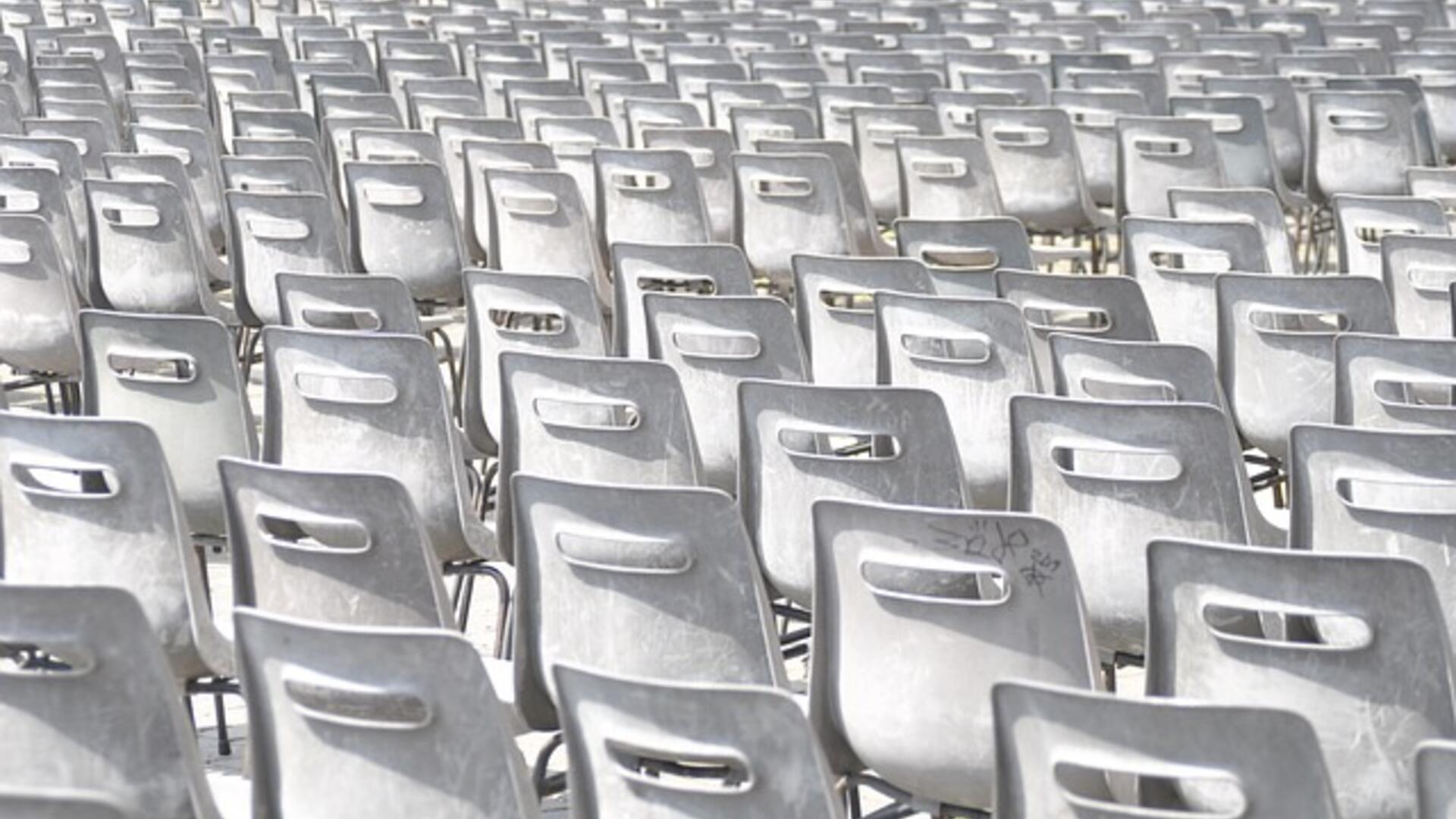 een foto met rijen en rijen witte stoelen